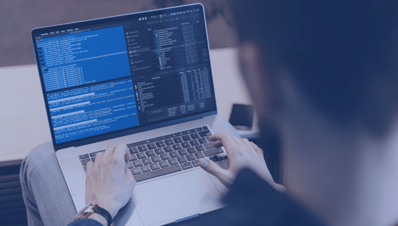 A person working at a desk with a laptop, representing the issues faced in software testing during fast growth.